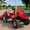 Red MT24 agricultural tractor with tall exhaust stack and plastic-covered seat, parked on a brick driveway on a sunny day.